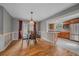 Dining Room features hardwood floors, wainscoting, access to the Kitchen and outdoor patio at 24699 Us Hwy 40, Golden, CO 80401