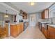 An open kitchen features granite countertops, stainless steel appliances, tile backsplash, and wood cabinets at 24699 Us Hwy 40, Golden, CO 80401