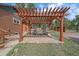 Cozy outdoor patio with wooden pergola and seating area at 24699 Us Hwy 40, Golden, CO 80401