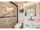 Updated bathroom with modern vanity and walk-in shower at 13791 E Lehigh Ave # A, Aurora, CO 80014