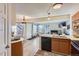 Open concept kitchen with island, view into living room at 13791 E Lehigh Ave # A, Aurora, CO 80014