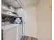 Convenient laundry area with washer, dryer, and shelving at 13791 E Lehigh Ave # A, Aurora, CO 80014