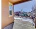 Covered patio overlooking a snow-covered backyard with neighborhood view at 4967 S Ukraine St, Aurora, CO 80015