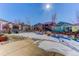 Spacious backyard with a large patio, partially covered in snow at 4967 S Ukraine St, Aurora, CO 80015