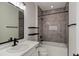 Bathroom with grey tiled walls and a bathtub at 4967 S Ukraine St, Aurora, CO 80015