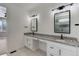 Double vanity bathroom with granite countertop and modern fixtures at 4967 S Ukraine St, Aurora, CO 80015