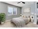 Virtually staged bedroom with a queen-size bed and window shutters at 4967 S Ukraine St, Aurora, CO 80015