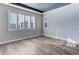 Bright bedroom featuring wood-look floors and plantation shutters at 4967 S Ukraine St, Aurora, CO 80015