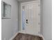 Bright entryway with a white door and wood-look flooring at 4967 S Ukraine St, Aurora, CO 80015