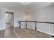 Upstairs hallway with hardwood floors and light paint at 4967 S Ukraine St, Aurora, CO 80015