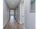 Bright hallway with barn door and hardwood floors at 4967 S Ukraine St, Aurora, CO 80015