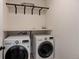 Laundry room with LG washer and dryer and overhead shelving at 4967 S Ukraine St, Aurora, CO 80015