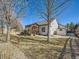 Large backyard with wooden patio, perfect for outdoor living at 2227 Chestnut Cir, Erie, CO 80516