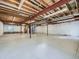 Unfinished basement area with exposed ceiling beams, a concrete floor, and white walls at 2227 Chestnut Cir, Erie, CO 80516