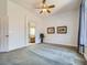 Spacious bedroom with neutral paint, carpet, ceiling fan, and view to the ensuite bathroom at 2227 Chestnut Cir, Erie, CO 80516