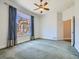 Bedroom with carpet, neutral paint, ceiling fan, and views of the backyard at 2227 Chestnut Cir, Erie, CO 80516