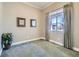 Neutral bedroom with a large window, wall art, and a lush green plant adding a touch of nature at 2227 Chestnut Cir, Erie, CO 80516