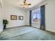 Large bedroom with a ceiling fan, carpet, and a window with blue patterned curtains at 2227 Chestnut Cir, Erie, CO 80516