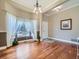 Inviting foyer with beautiful hardwood flooring, elegant chandelier, and large bay window with decorative curtains at 2227 Chestnut Cir, Erie, CO 80516