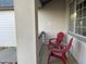 Relaxing front porch with a pair of red chairs, a small table, and view of the home's exterior at 2227 Chestnut Cir, Erie, CO 80516