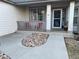 Inviting front porch with cozy seating area and stylish stone landscaping leading to the front door of this beautiful home at 2227 Chestnut Cir, Erie, CO 80516