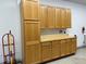 Garage with built-in cabinets and a wooden countertop, offering functional storage and workspace at 2227 Chestnut Cir, Erie, CO 80516