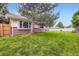 Expansive backyard featuring lush green grass, trees, and privacy fencing at 3743 W 103Rd Dr, Westminster, CO 80031