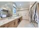 Spacious bathroom with double vanity, and a glass-enclosed shower, complemented by neutral tiles at 3743 W 103Rd Dr, Westminster, CO 80031