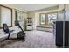 A bonus room featuring a bay window, exercise equipment, and comfortable seating at 3743 W 103Rd Dr, Westminster, CO 80031