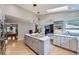 Modern kitchen with an island, stainless appliances, and an open view of the dining and living areas at 3743 W 103Rd Dr, Westminster, CO 80031