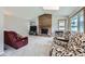Cozy living room featuring a brick fireplace, vaulted ceilings, and a large window at 3743 W 103Rd Dr, Westminster, CO 80031