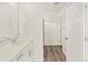 Bright bathroom featuring modern fixtures, a sleek white vanity, and wood-look flooring at 755 N Tibet St, Aurora, CO 80018