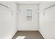 Walk-in closet with neutral carpet, window, and bars for hanging clothes at 755 N Tibet St, Aurora, CO 80018