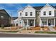 Charming townhome features a stone and white siding exterior with a covered front porch and landscaped front yard at 755 N Tibet St, Aurora, CO 80018