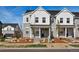 Charming townhome features a stone and white siding exterior with a covered front porch and landscaped front yard at 755 N Tibet St, Aurora, CO 80018