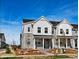 Charming townhome features a stone and white siding exterior with a covered front porch and landscaped front yard at 755 N Tibet St, Aurora, CO 80018