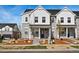 Charming townhome features a stone and white siding exterior with a covered front porch and landscaped front yard at 755 N Tibet St, Aurora, CO 80018