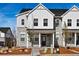 Charming townhome features a stone and white siding exterior with a covered front porch and landscaped front yard at 755 N Tibet St, Aurora, CO 80018