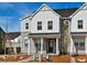 Charming townhome features a stone and white siding exterior with a covered front porch and landscaped front yard at 755 N Tibet St, Aurora, CO 80018