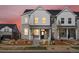 Charming townhome features a stone and white siding exterior with a covered front porch and landscaped front yard at 755 N Tibet St, Aurora, CO 80018