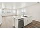 Bright, open concept kitchen with stainless steel dishwasher, island, and hardwood floors at 755 N Tibet St, Aurora, CO 80018