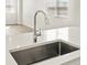 Close up of stainless steel sink with hardwood floors and multiple windows at 755 N Tibet St, Aurora, CO 80018