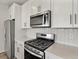 Gourmet kitchen with stainless steel appliances and white cabinetry at 755 N Tibet St, Aurora, CO 80018