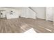 Spacious living room features hardwood floors, a kitchen with island, staircase and multiple doors at 755 N Tibet St, Aurora, CO 80018