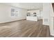 Open-concept living area with hardwood floors seamlessly flows into the modern kitchen with white cabinets at 755 N Tibet St, Aurora, CO 80018
