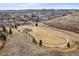 Aerial view showcasing a community playground with surrounding sidewalks and open space at 7268 Greenwater Cir, Castle Rock, CO 80108