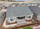 A home's backyard view showcases a well-maintained patio, a fenced yard and modern outdoor living space at 7268 Greenwater Cir, Castle Rock, CO 80108