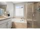 Bright bathroom features a soaking tub, glass shower, and granite vanity at 7268 Greenwater Cir, Castle Rock, CO 80108