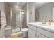 Bathroom featuring a white sink vanity, stylish mirror, and modern shower with glass doors at 7268 Greenwater Cir, Castle Rock, CO 80108