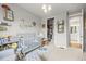 Bedroom featuring crib, rocking chair, and closet with access to a bathroom at 7268 Greenwater Cir, Castle Rock, CO 80108